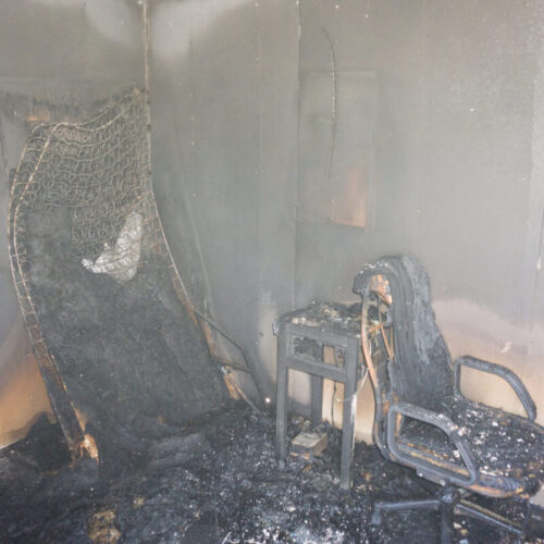 Chair and furniture in room with fire damage